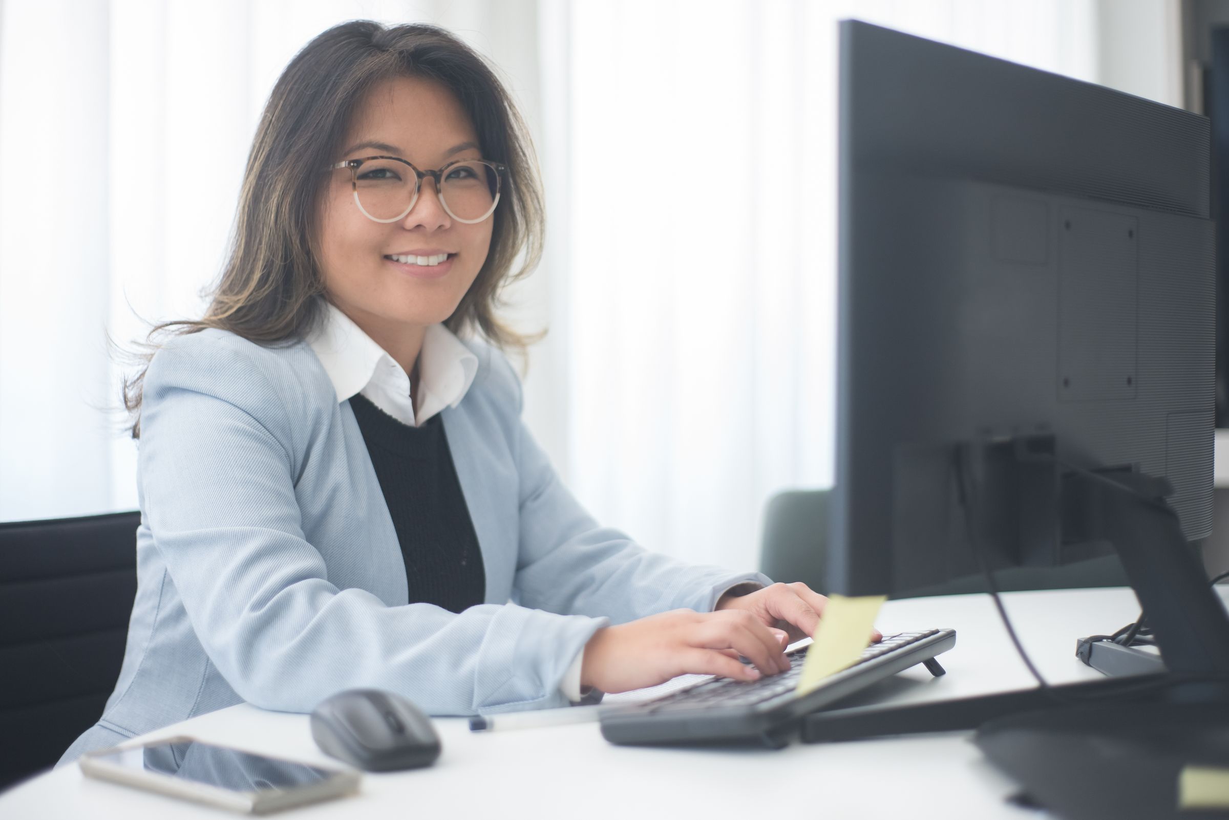 Smiling specialist at her workstation.