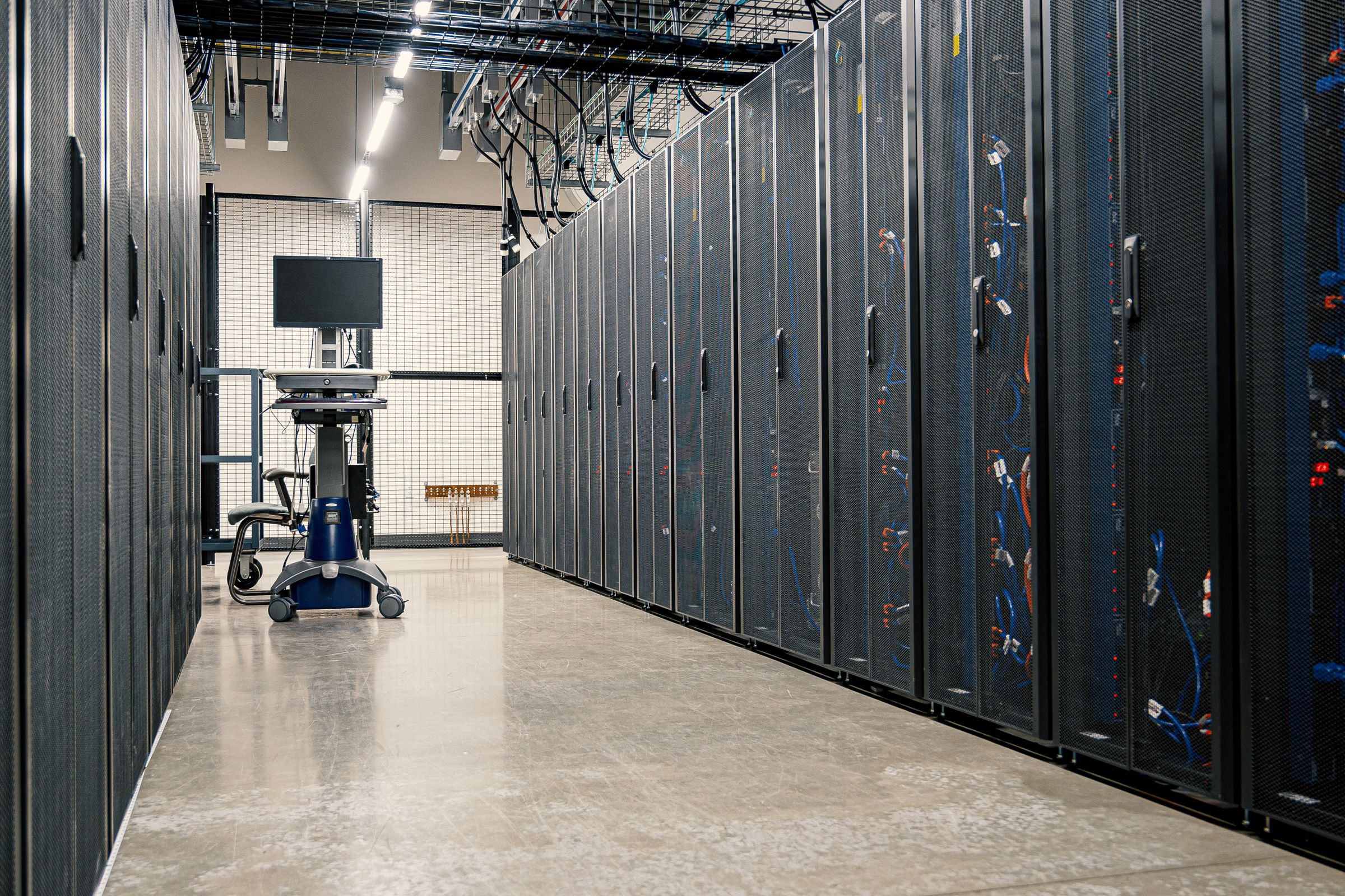 Data centre aisle lined with server cabinets.