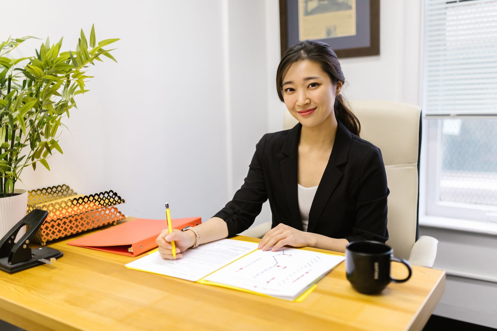 Consultant at her desk, writing up notes.
